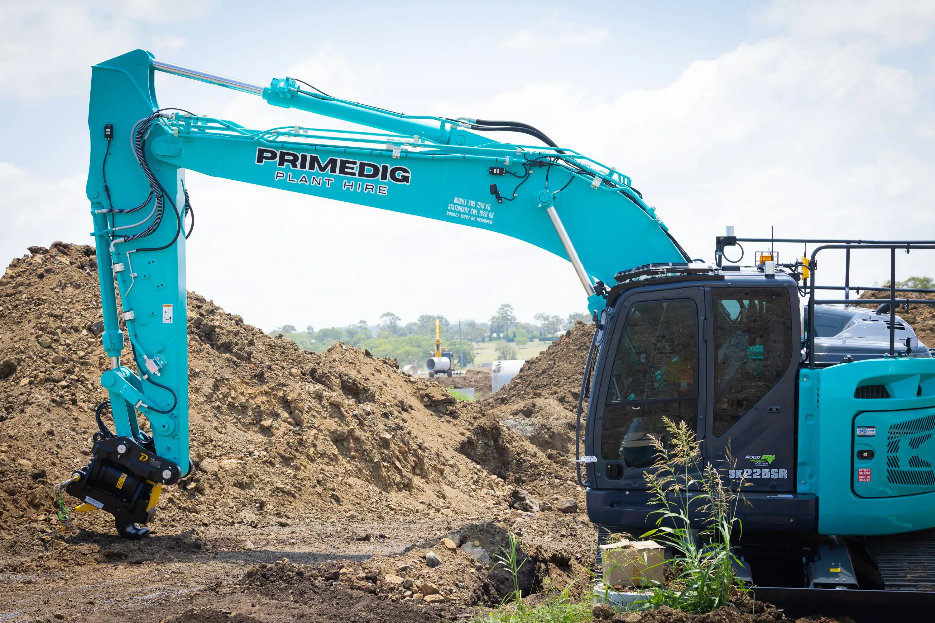 Kobelco 22.5 tonne excavator with a tilt hitch working beside a spoil pile